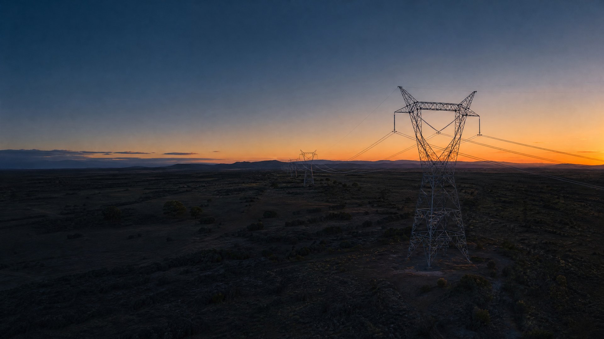 High-voltage transmission line across open landscape